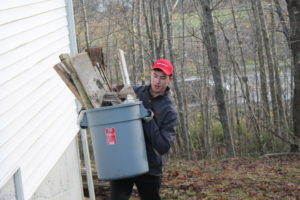 Andrew Willison with the first bucket full of debris being brought up to the truck. (Healey photo)
