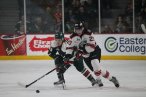 Andrew Coxhead of the Quebec Remparts (#20) outraces Halifax Moosehead Otto Sommpi for the puck during a Nov. 24 game between the two at Scotiabank Centre. It was Coxhead’s first game in front of family and friends, and against the team he grew up rooting for in Halifax. (Healey photo)