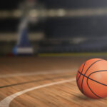 Basketball,On,Court,Floor,Close,Up,With,Blurred,Arena,In
